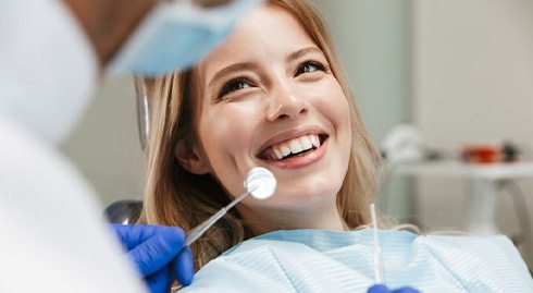 Lady smiles at dentist