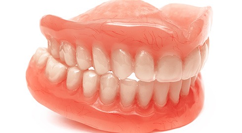 Two partial dentures next to each other on a white background