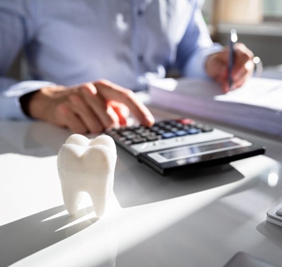 a person calculating the cost of a smile makeover