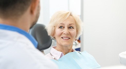 patient smiling after getting dental implant