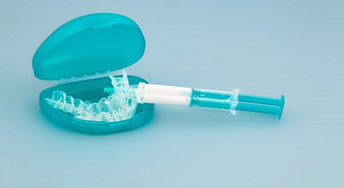 a teeth whitening syringe and trays