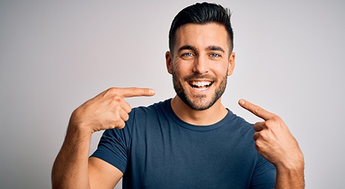 a patient pointing to his smile